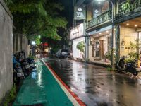 motorcyclists and pedestrians on a city street during the rainy night time and rain