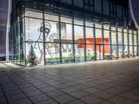 an empty building with glass windows, with christmas decorations in the front and outside it