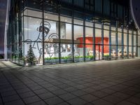 an empty building with glass windows, with christmas decorations in the front and outside it