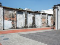 two walls side by side with red brick and cement on them to show the different colors and textures