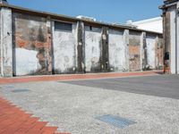 two walls side by side with red brick and cement on them to show the different colors and textures