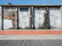 two walls side by side with red brick and cement on them to show the different colors and textures