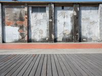 two walls side by side with red brick and cement on them to show the different colors and textures