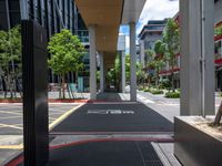 a car on a city street with cars parked behind it and a building next to the sidewalk