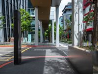 a car on a city street with cars parked behind it and a building next to the sidewalk