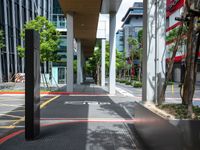 a car on a city street with cars parked behind it and a building next to the sidewalk