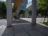 a photo of an outside walkway with street signs and buildings in the background the sign reads