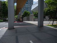 a photo of an outside walkway with street signs and buildings in the background the sign reads