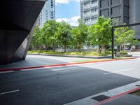 street with trees on both sides and a road below it that has red lines painted