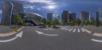 a large empty intersection next to tall buildings and trees in a city skyline setting, in full hd