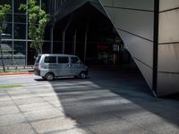 the street is empty except for cars to take it home from the bus stop and pick up the next one