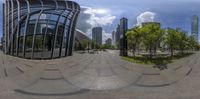 a distorted panorama view looking at an office building in the city with tall buildings, and a bicycle on the pavement below