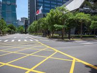 a view of a city street with a flag flying at the top of it and yellow lines on the road