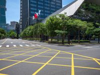 a view of a city street with a flag flying at the top of it and yellow lines on the road