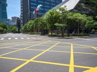 a view of a city street with a flag flying at the top of it and yellow lines on the road