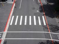 a view of a crosswalk and a road in an urban area with the traffic lights