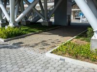 a walkway on an overpass in the city with a sign underneath it for pedestrians to see