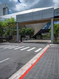 a red line on the street next to the curb in a city with high rise building