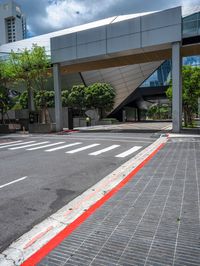 a red line on the street next to the curb in a city with high rise building