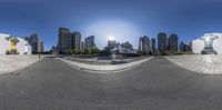 an image of a reflection of a city on a mirror image of the sun rising over the buildings