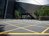 a road in front of a modern building with a few trees on it at the sides of the road