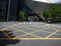 a road in front of a modern building with a few trees on it at the sides of the road