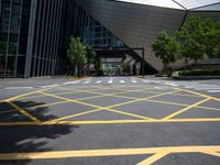 a road in front of a modern building with a few trees on it at the sides of the road