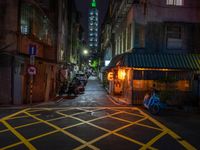 an alley with an umbrella, parked motorcycles and the oriental architecture at night - - a woman sits alone in the dark