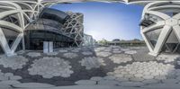 a large circular courtyard with various white pebbles in it and an office building in the distance