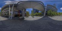 a fish eye view of the intersection of a shopping center and a car park with several chairs