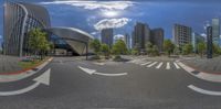 an image of a road at an intersection with lots of buildings and streets in the background