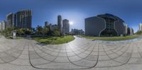 the image shows a circular view of buildings from inside the sphere, with buildings in the background