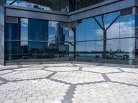 a room with hexagonal floor tiles in front of large windows with a view of a city in the background