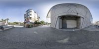 a fish eye lens is seen of a street in front of a building with a doorway