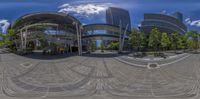 a fisheye shot of an entrance to a building on a street corner, with buildings in the background