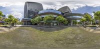 a 360 - view of the outside of a modern building surrounded by trees and people