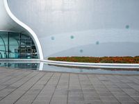 there is an open space next to the building, with colorful flowers in the background