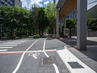 bike lanes and markings on the sidewalk in a city setting that has some buildings near it