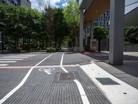 bike lanes and markings on the sidewalk in a city setting that has some buildings near it