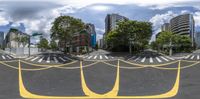 three way intersection with street divider and city skyline in the background, in the middle