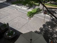 an overhead view of a street that has two empty spots on it that look like pavement