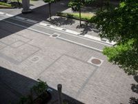 an overhead view of a street that has two empty spots on it that look like pavement