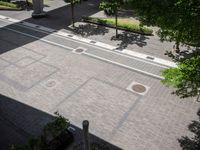 an overhead view of a street that has two empty spots on it that look like pavement