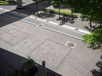 an overhead view of a street that has two empty spots on it that look like pavement