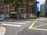 a couple of buildings with a green traffic light on the corner of the street as pedestrians ride across the road