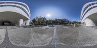 three spherical images of a plaza and some buildings on the other side of the street