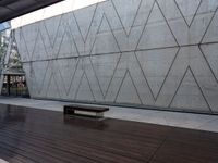 this area features wooden floors and a concrete wall with hexagonal patterns on it