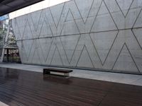 this area features wooden floors and a concrete wall with hexagonal patterns on it