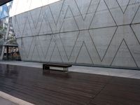 this area features wooden floors and a concrete wall with hexagonal patterns on it