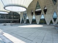 an empty building with large circular glass windows is shown with metal grates and metal grate